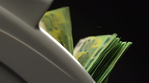 Money Counter Counting Euro Banknotes on Black