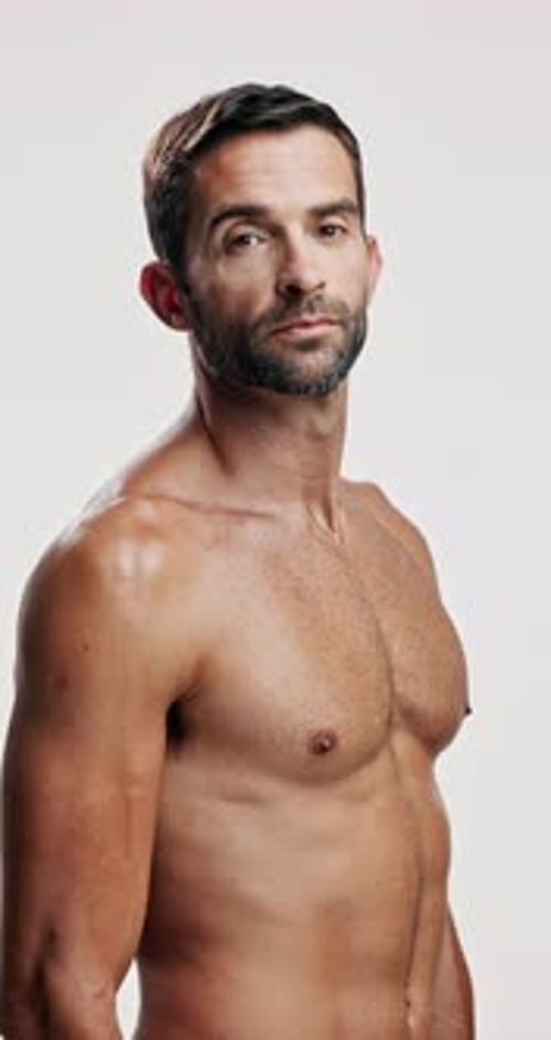 Fitness, shirtless and face of man, studio and healthy with bodybuilding for muscles and wellness