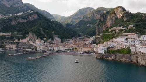 Aerial panoramic drone footage of Amalfi village in Amalfi coast of Italy during sunset