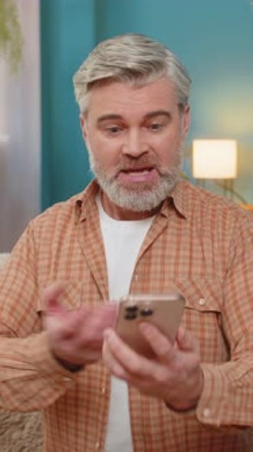 Gray Haired Man Talking Angrily On His Mobile Phone