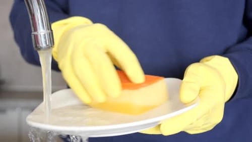 Close Up Hands of Men Washing Dishes in Kitchen