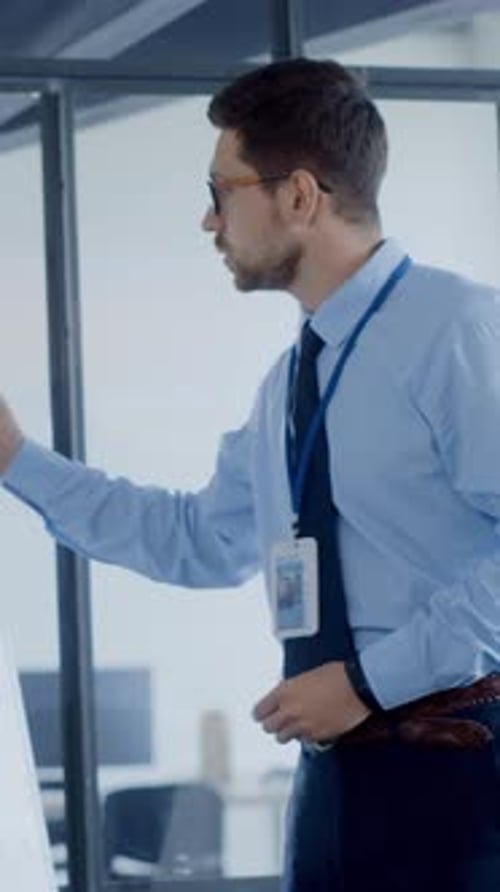 A Distinguished Professional Man Dressed in Formal Office Attire Proudly Displaying His ID Badge