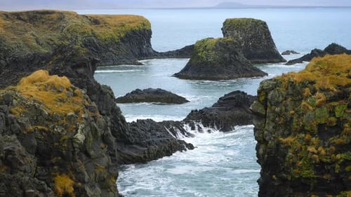Ocean Waves Crashing on Black Volcanic Cliff Coastline Pure Blue Sea Water and Unusual Shore in West