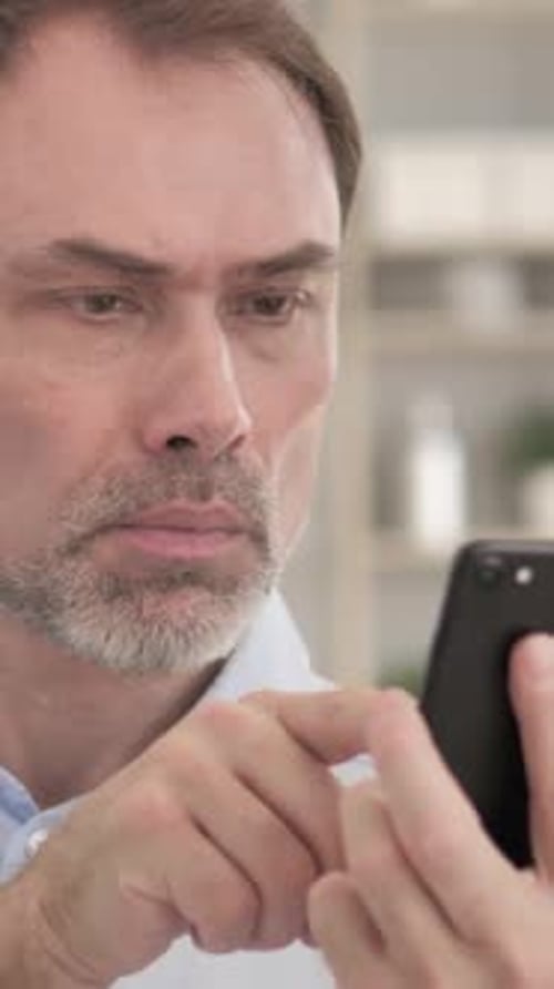 Man Using Smartphone Device in Home