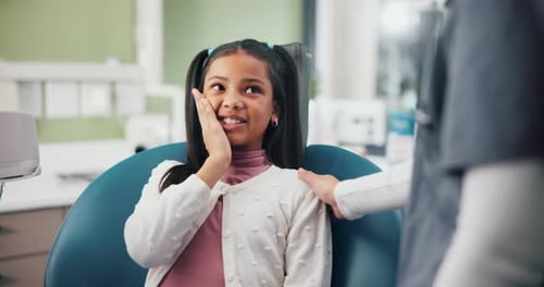 Girl Smiles While Visiting Dentist for Checkup