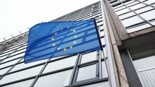 European Union Flag Waving from Modern Office Building