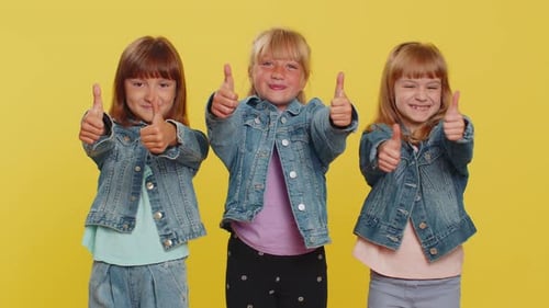 Three Happy Young Girls Giving Thumbs Up Sign