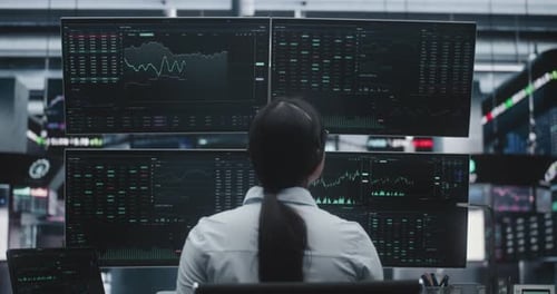 Female Trader With Long Hair Tied Back in Ponytail Works in Massive Innovative Digital Office