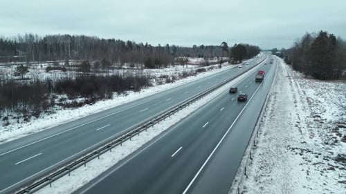 Enjoy an Impressive Aerial Footage Showcasing Scenic Winter Highway Traffic in a Beautiful Snowy