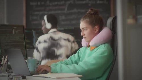 Female Programmer Coding on Laptop at Office Workplace