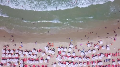Summertime in a public Beach with colorful umbrellas