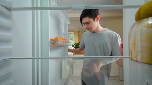 Boy Opening Fridge and Drinking Milk Straight From Bottle View From Inside of Fridge Young Thirsty