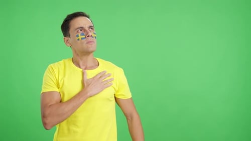 Man Listening to the Sweden National Anthem with Solemnity