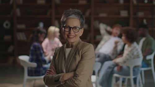 Counselor Smiling with Therapy Group in Background