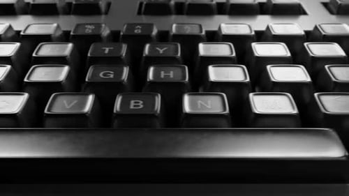 Transition close-up of a computer keyboard. Camera movement along the keyboard.