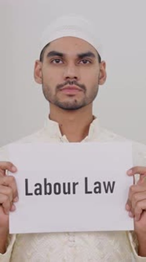 Vertical Video of Muslim Man Holding Labour Law Poster