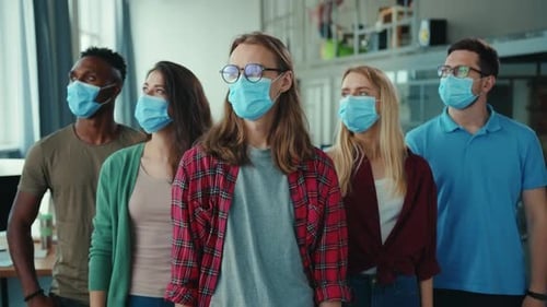 A Diverse Group of People Wearing Masks in a Contemporary Office Environment Setting