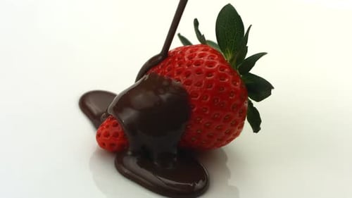 Chocolate Dripping Onto Strawberry Background
