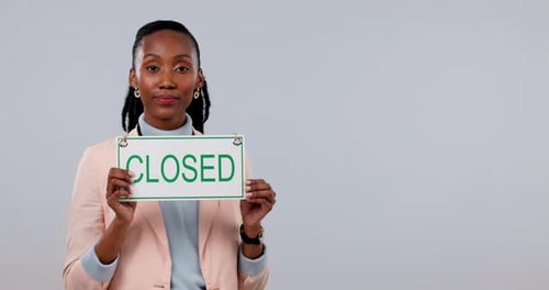 Black woman, closed sign and pointing of small business owner at mockup space in studio isolated