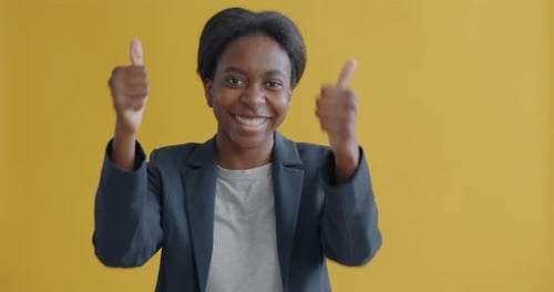 Smiling Woman Gives Two Thumbs Up Gesture