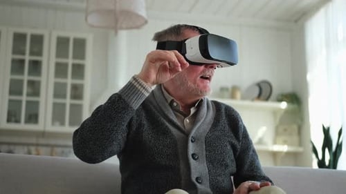 Senior Man Experiences Virtual Reality at Home