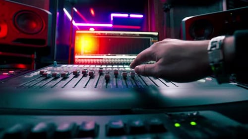 Close Up the Recording Room Dark with Neon Lighting in the Studio the Sound Engineer Works with the