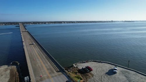 Drone shot of the Atlantic Beach Bridge with Morehead City in the distance with boats