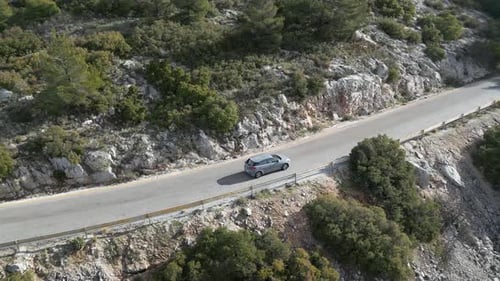 Drone Footage of a Vehicle Moving on a Scenic Forest Route