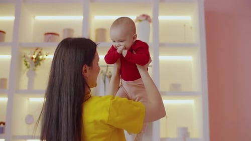Loving Mother Embracing Baby in Bright Home