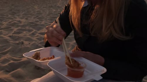 Beach Sunset Delight: Enjoying Food by the Sea