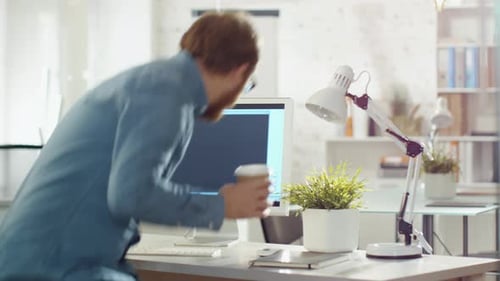 Man Typing Code at Computer in Bright Office