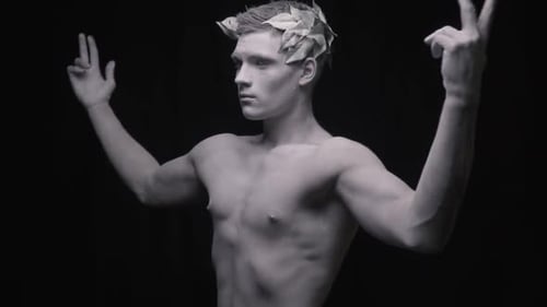 Living Statue of the Fit Man Spreads His Arms and Flexes