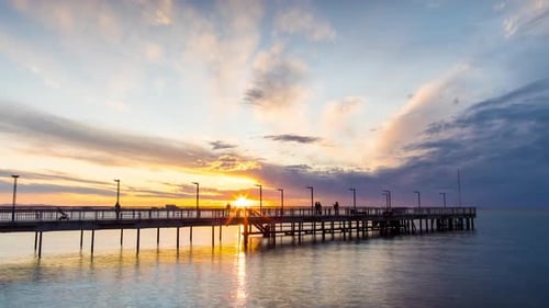 Side View of the Pier on the Black Sea Against the Background of the Sky and Sunset