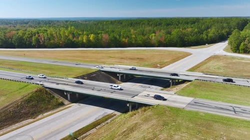 Elevated View of Freeway Exit Junction Over Road Lanes with Fast Moving Traffic Cars and Trucks