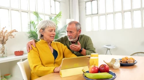 Senior Couple Using Tablet in the Morning at Home