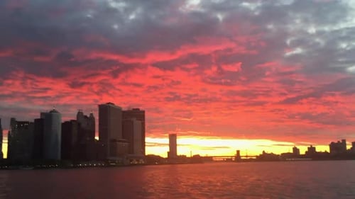 Sunrise over the skyline of New York City.
Camera pans left revealing beautiful summer morning sunri