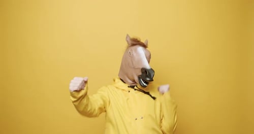Horse Masked Figure Dancing on Yellow Background