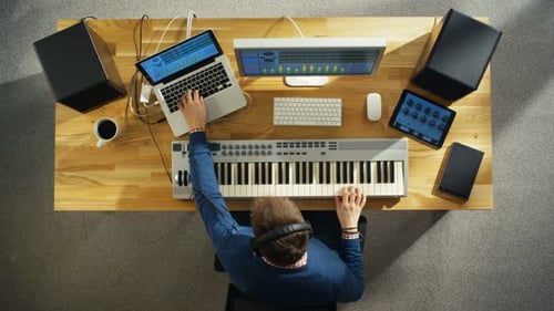 Top View of a Musician Creating Music at His Studio, Playing on a Musical Keyboard. His Studio is S
