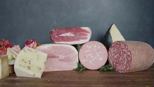Italian deli meats and cheeses on display. Prosciutto, salami, mortadella, and various cheeses in an