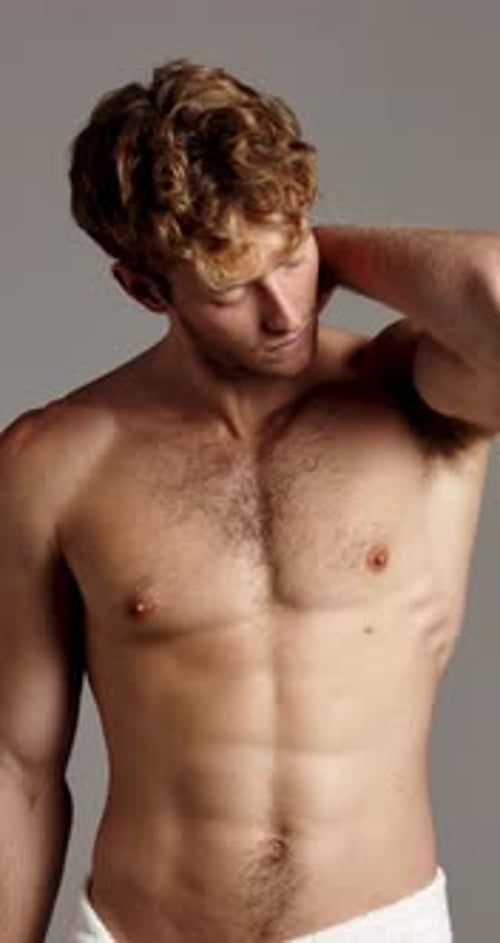 Confident, skincare and face of man with towel in studio for wellness, cleaning and hygiene routine