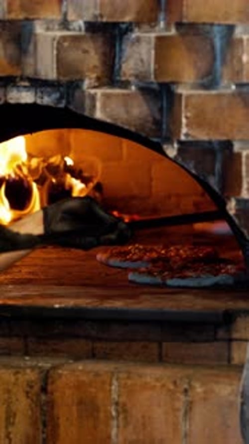 Wood-Fired Pizza Baking in a Brick Oven