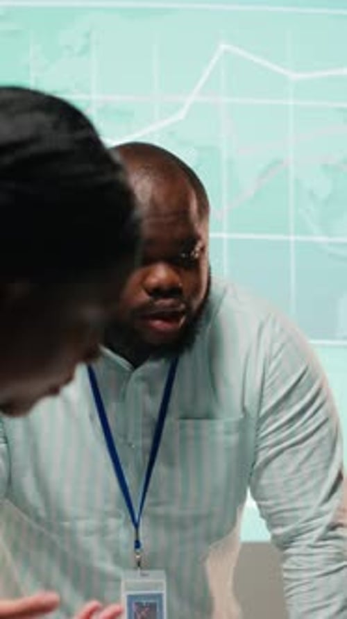 Team Collaborates Analyzing Data in Workplace