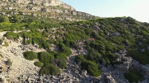 Aerial View of Rocky Coastline Leading to Blue Bay