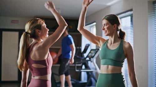 Women High-Fiving at the Gym After Exercise