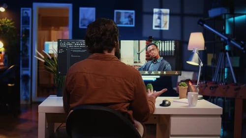 Man Participates in Virtual Meeting at Home