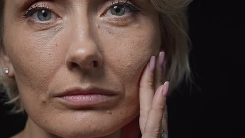 Woman's Close-Up Portrait with Hand on Face in Studio