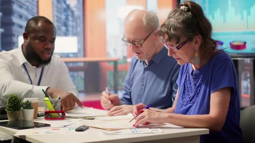 Elderly Woman Shaking Hands with Financial Broker in Modern Office