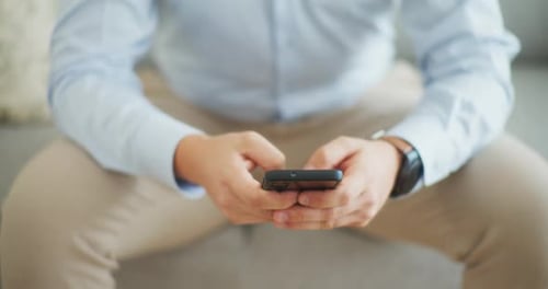 Close Up of Man Texting on Smartphone