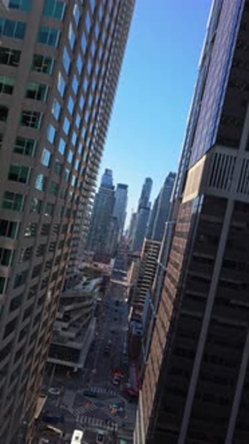Dutch Tilt Flying Over Toronto Financial District Bustling Urban Canyon with Modern Skyscrapers and