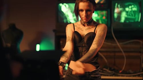 Sexy Young Woman with Tattooed Slender Body Dancing for Camera in Studio Professional Shooting of